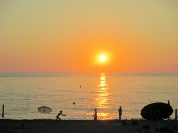 sunset at the beach / sunset at the beach playing volleyball by the sea