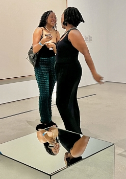 Friends in a museum / Two girls talking in a museum