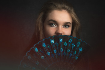 Fan Girl / Portrait shot of the lovely Chloe looking out from behind a hand fan.