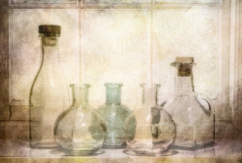 At the window / A selection of glass bottles on a window sill.